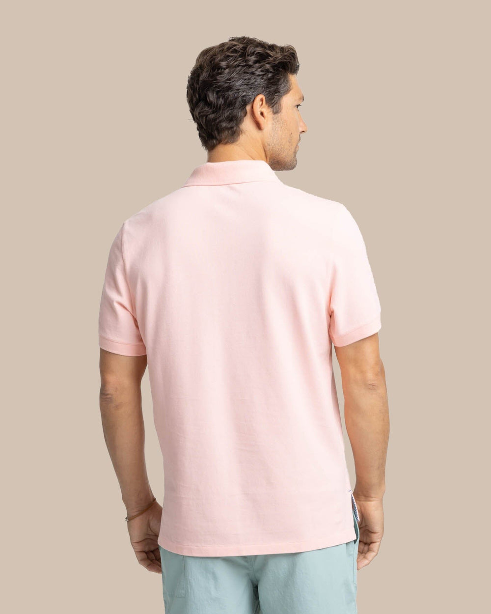 The back view of the Men's New Skipjack Polo Shirt by Southern Tide - Pale Rosette Pink