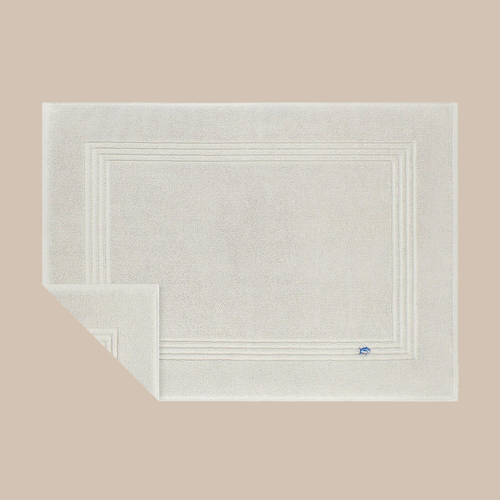 The front corner view of the Southern Tide Bath Mat by Southern Tide - Harpoon Grey