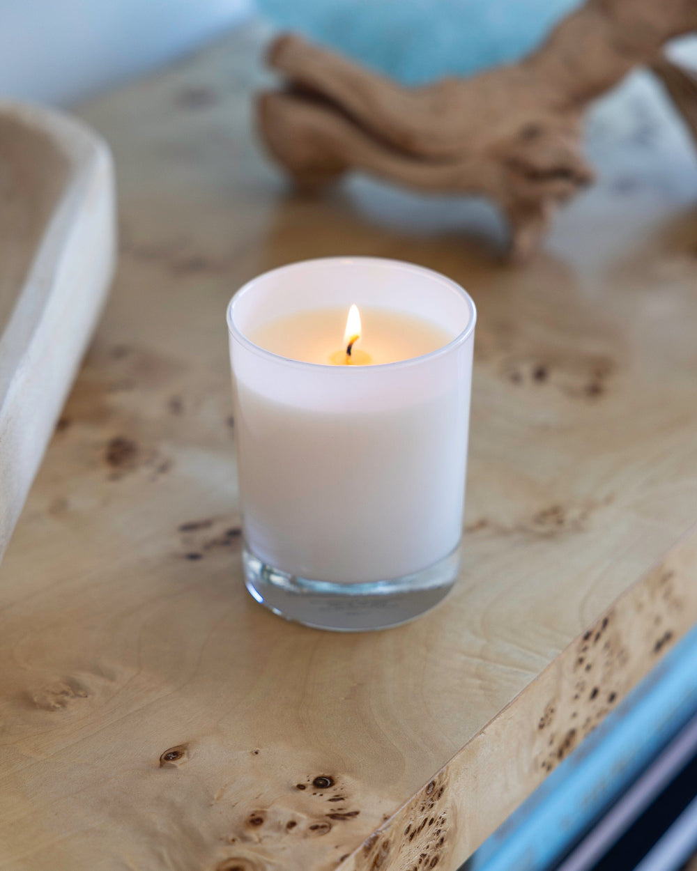 The lifestyle view of the Southern Tide Coral Scented Candle by Southern Tide - Coral