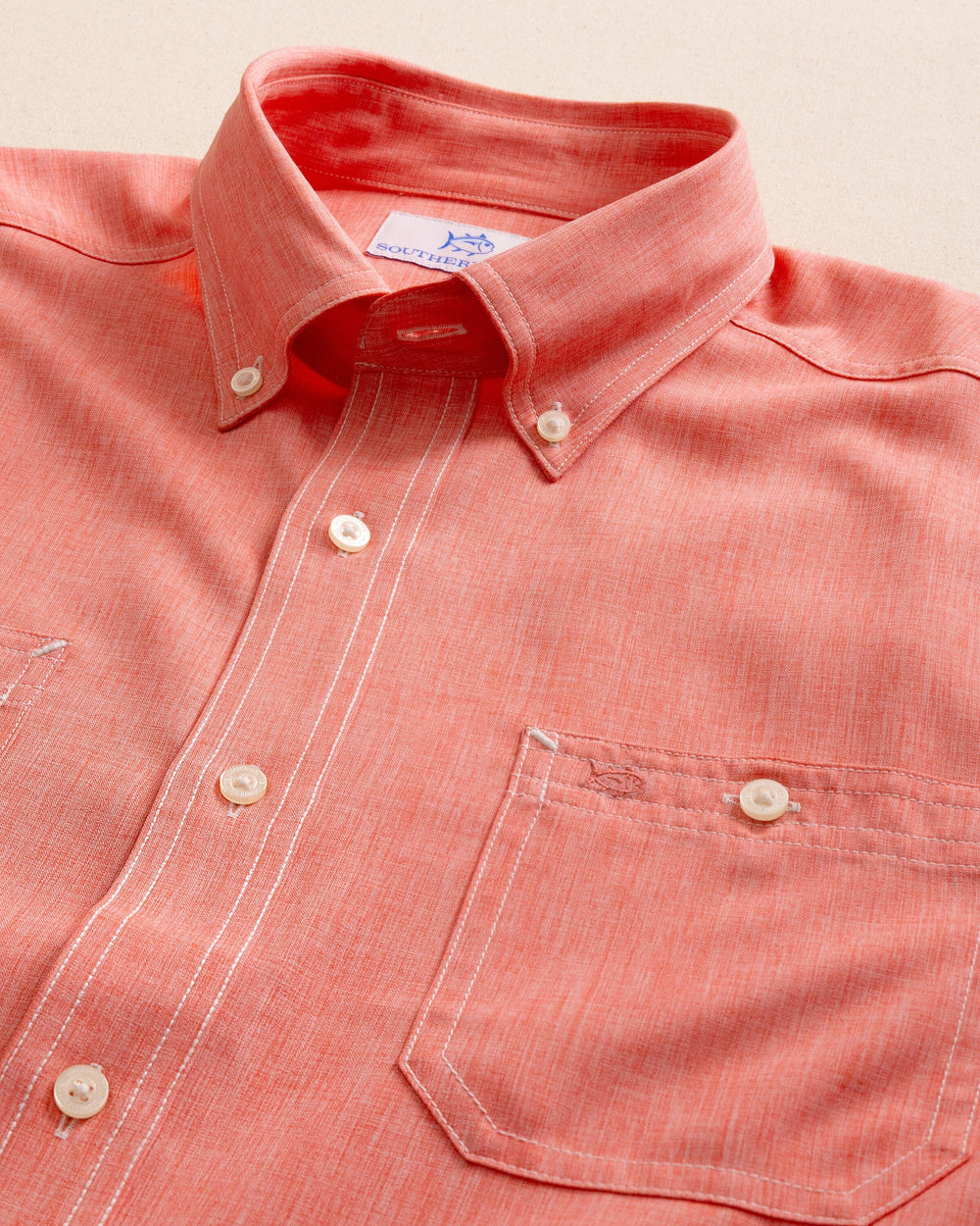 The detail view of the Southern Tide Dock Shirt by Southern Tide - Sunkist Coral