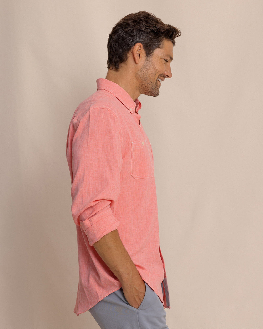 The side view of the Southern Tide Dock Shirt by Southern Tide - Sunkist Coral