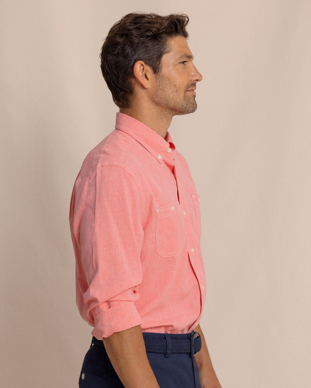 The side view of the Southern Tide Dock Shirt by Southern Tide - Sunkist Coral