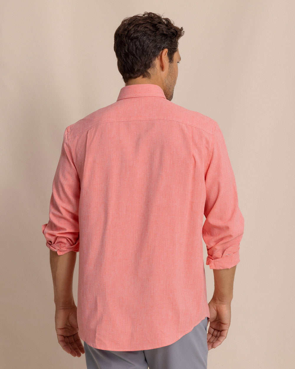 The back view of the Southern Tide Dock Shirt by Southern Tide - Sunkist Coral