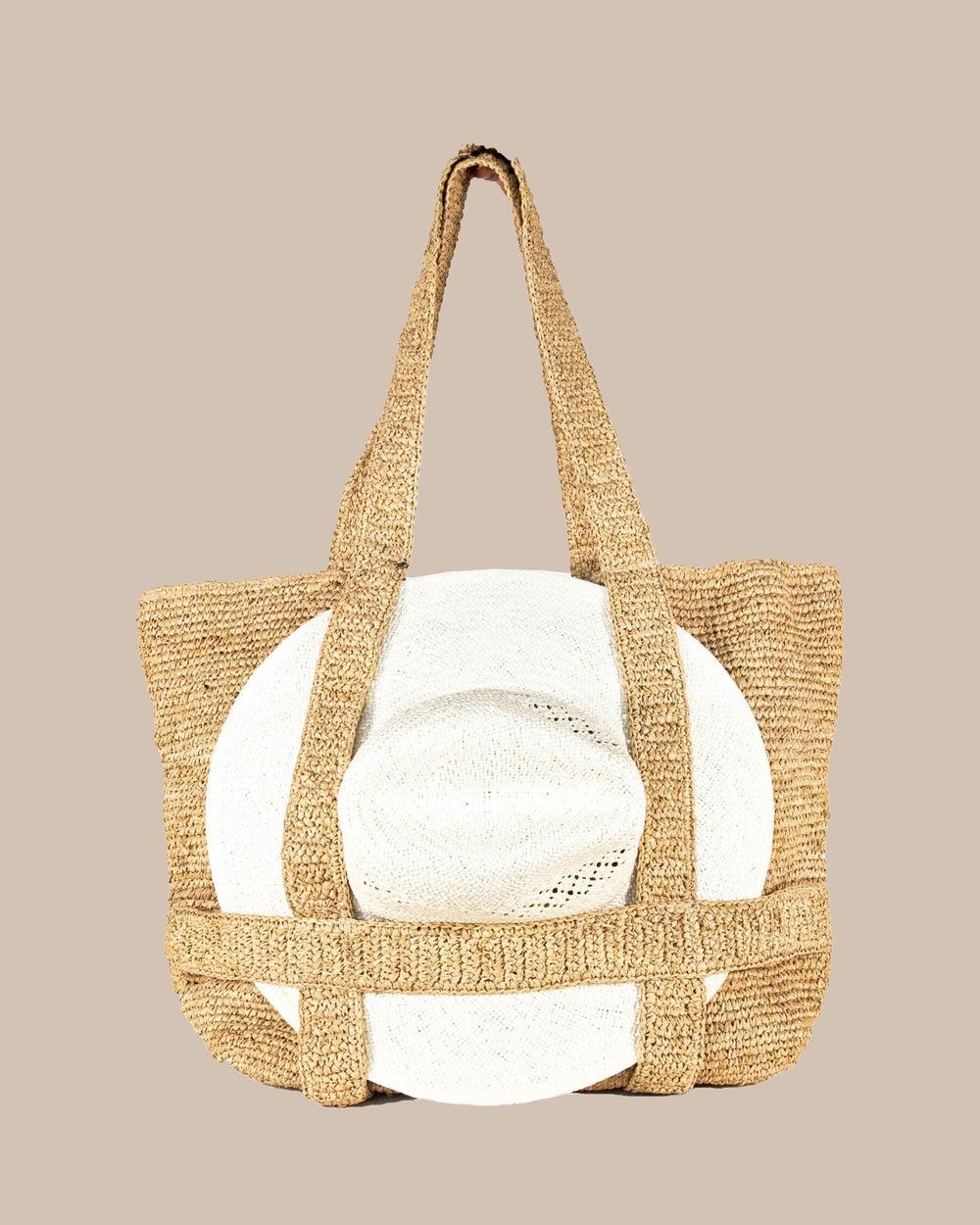 The front with hat view of the Southern Tide Straw Hat Carrier Beach Tote by Southern Tide - Natural