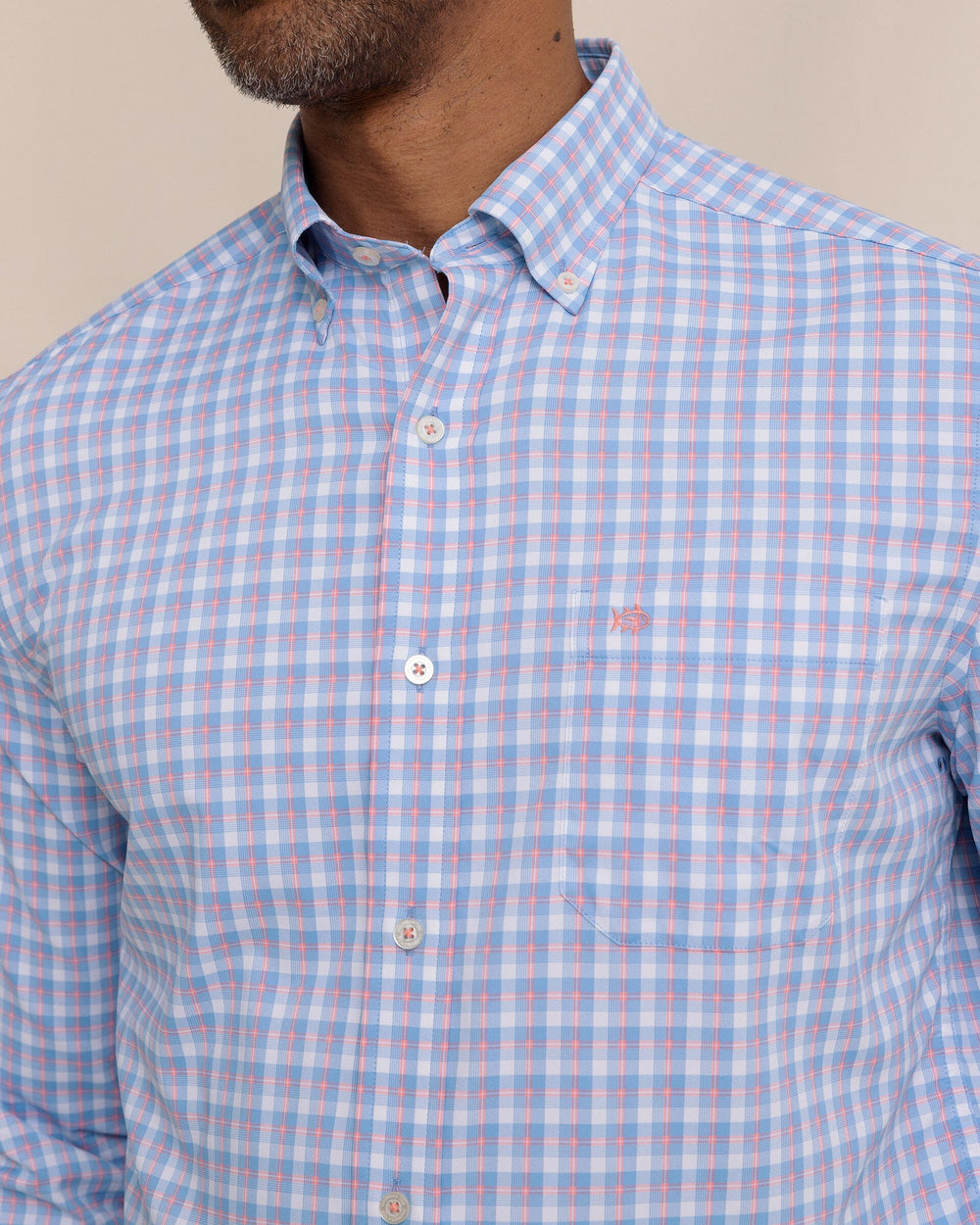 The detail view of the Southern Tide Sunset Harbor brrr°® Intercoastal Sport Shirt by Southern Tide - Sunkist Coral