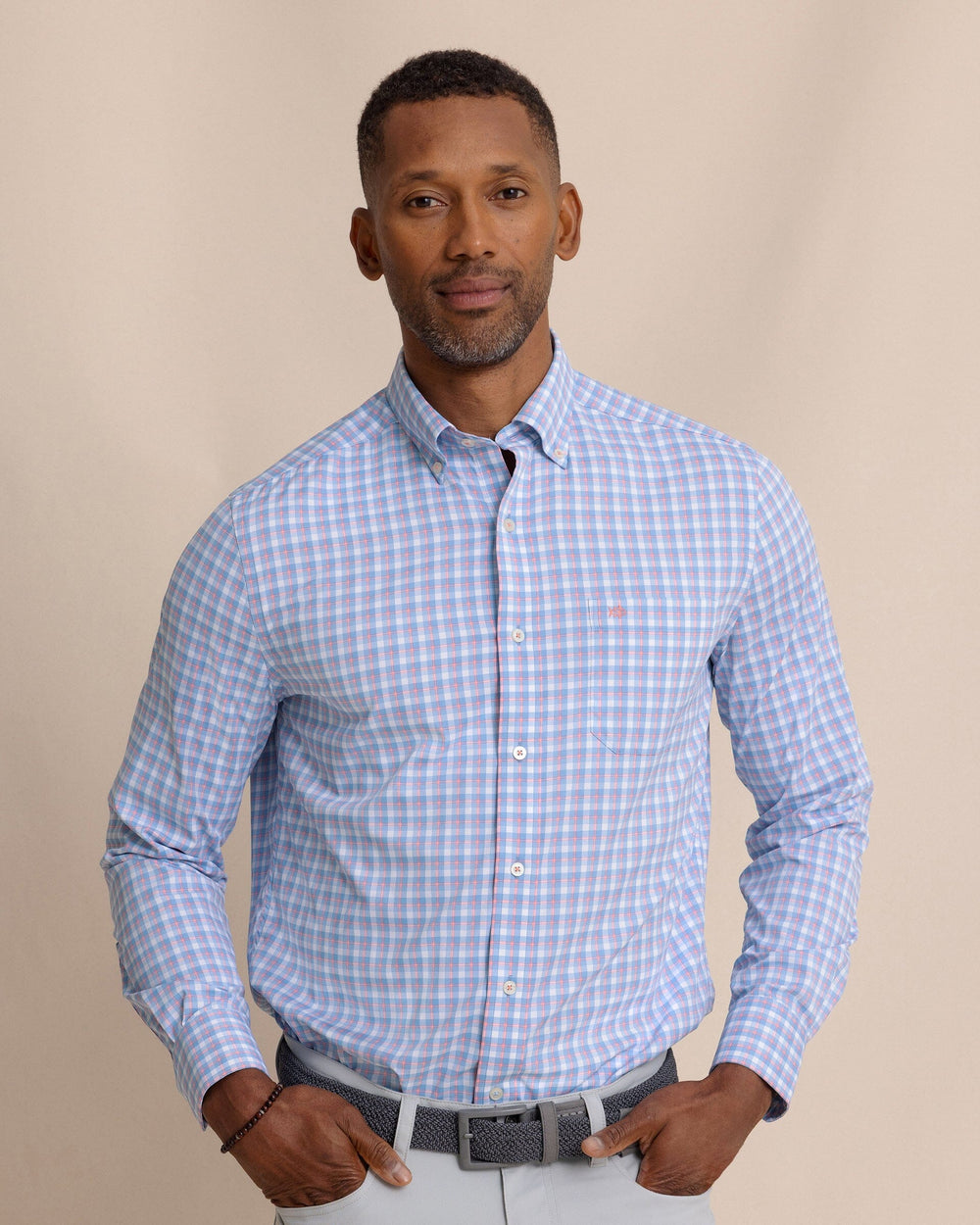 The front view of the Southern Tide Sunset Harbor brrr°® Intercoastal Sport Shirt by Southern Tide - Sunkist Coral