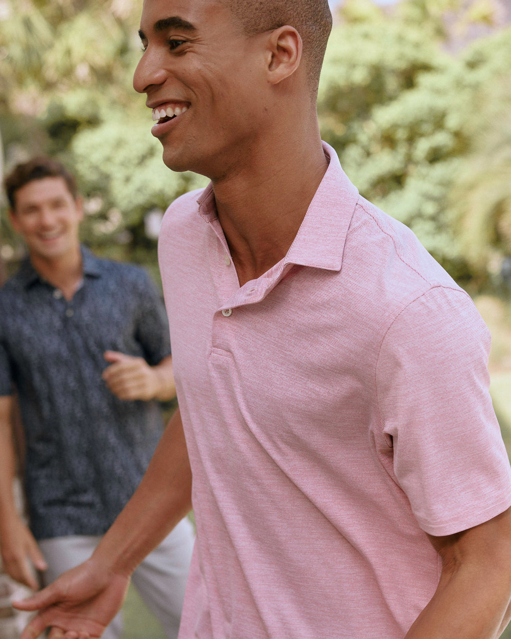 The lifestyle view of the Southern Tide Team Colors Driver Spacedye Polo Shirt by Southern Tide - Crimson