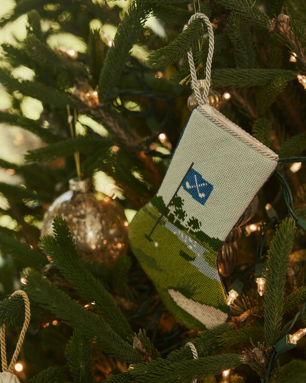 The lifestyle view of the Southern Tide Tee Time Golf Needlepoint Stocking by Southern Tide - Blue