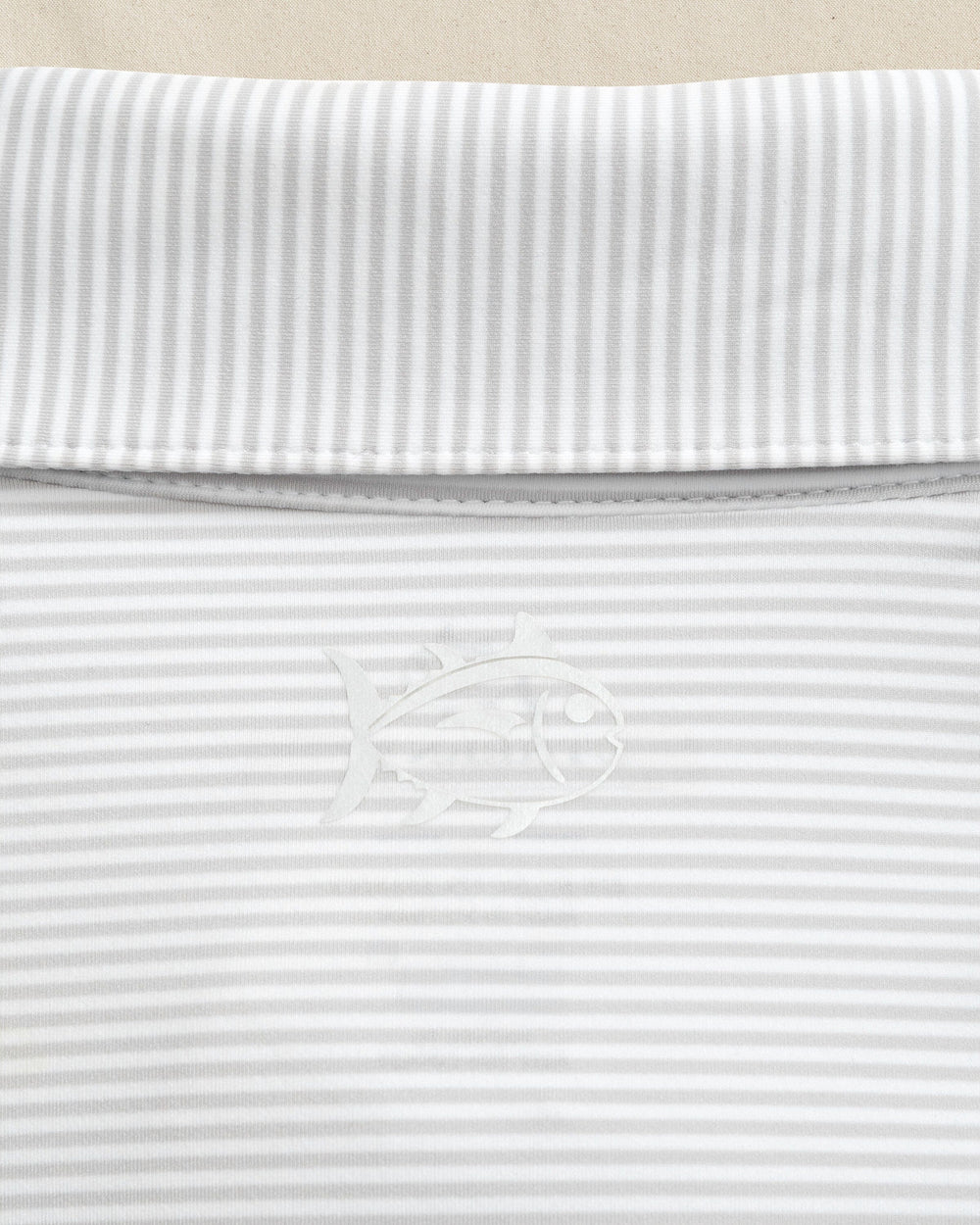 The detail view of the Southern Tide Texas Longhorns brrr°®-eeze Meadowbrook Stripe Polo by Southern Tide - Platinum Grey