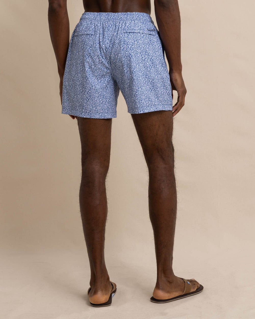 The back view of the Southern Tide That Floral Feeling Swim Trunk by Southern Tide - Coronet Blue