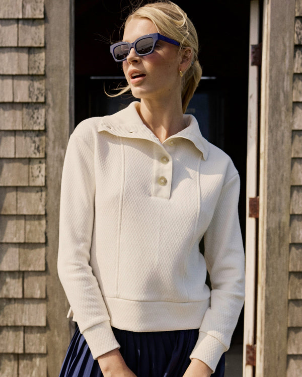 The lifestyle view of the Southern Tide Tonya Button Mock Pullover by Southern Tide - Sand White