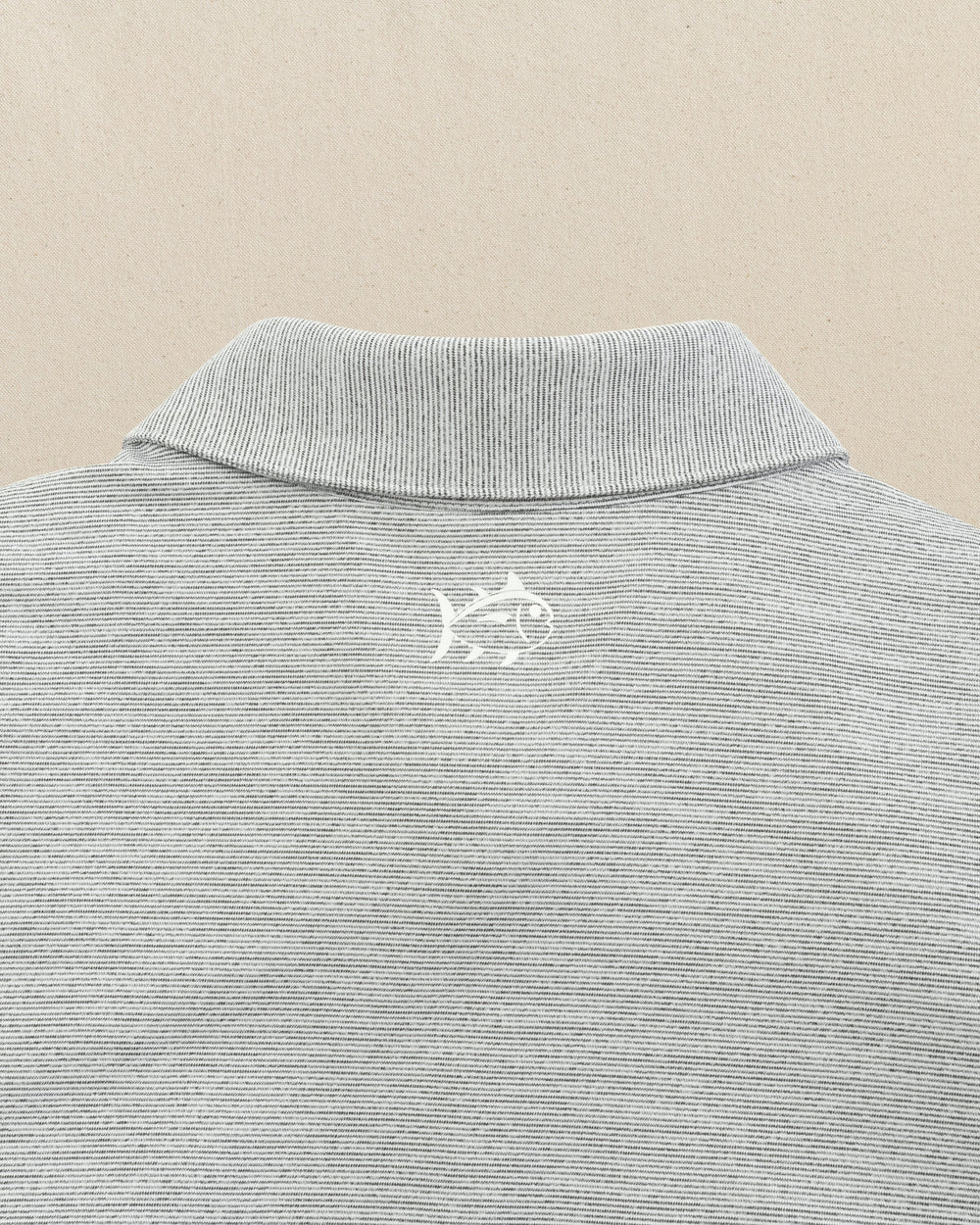 The detail view of the Southern Tide UCF Knights Driver Spacedye Polo by Southern Tide - Black