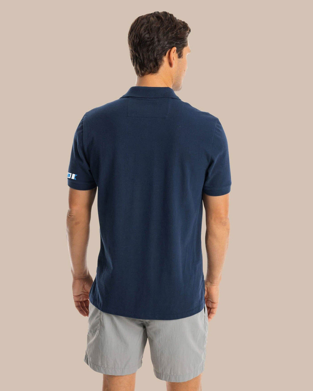 The back view of the Southern Tide USA Nautical Flags Skipjack Polo by Southern Tide - True Navy