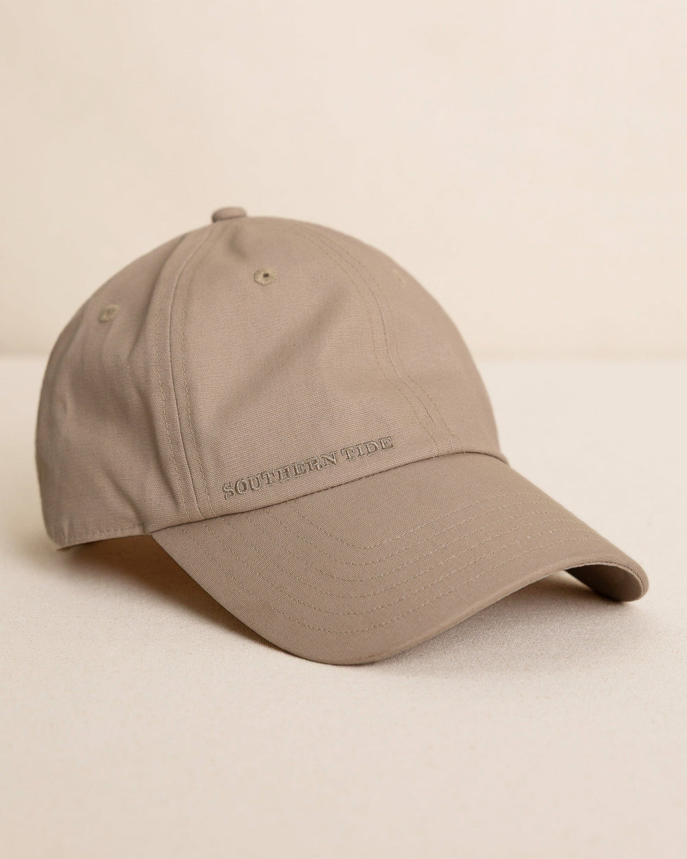 The front view of the Southern Tide Waxed Canvas Leather Strap Hat by Southern Tide - Sandstone Khaki