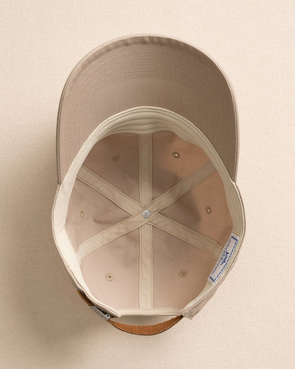 The under view of the Southern Tide Waxed Canvas Leather Strap Hat by Southern Tide - Sandstone Khaki