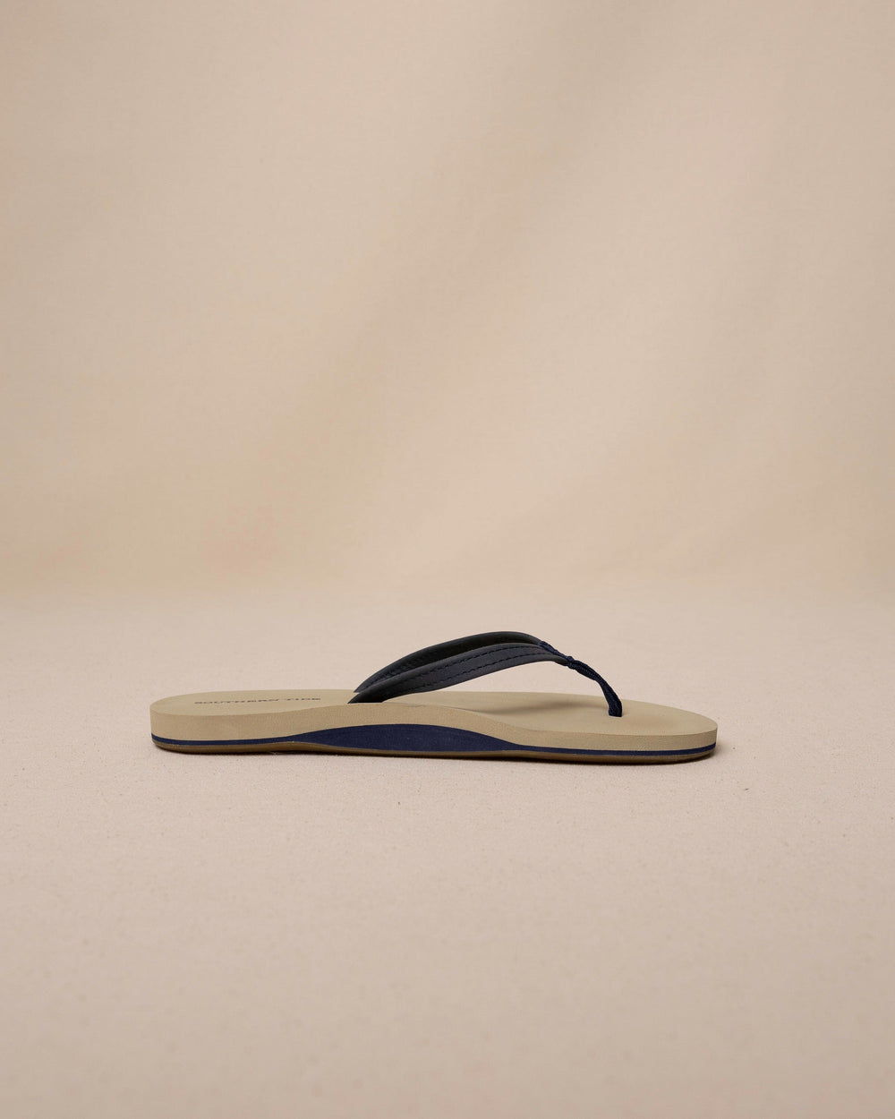 The side view of the Southern Tide Women's Weekend Navy Leather Flipjacks by Southern Tide - Nautical Navy