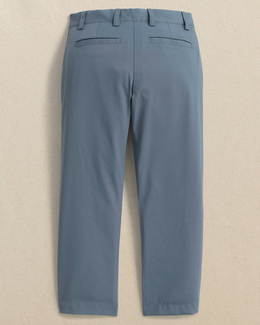 The back view of the Youth Leadhead Performance Pant by Southern Tide - Blue Haze