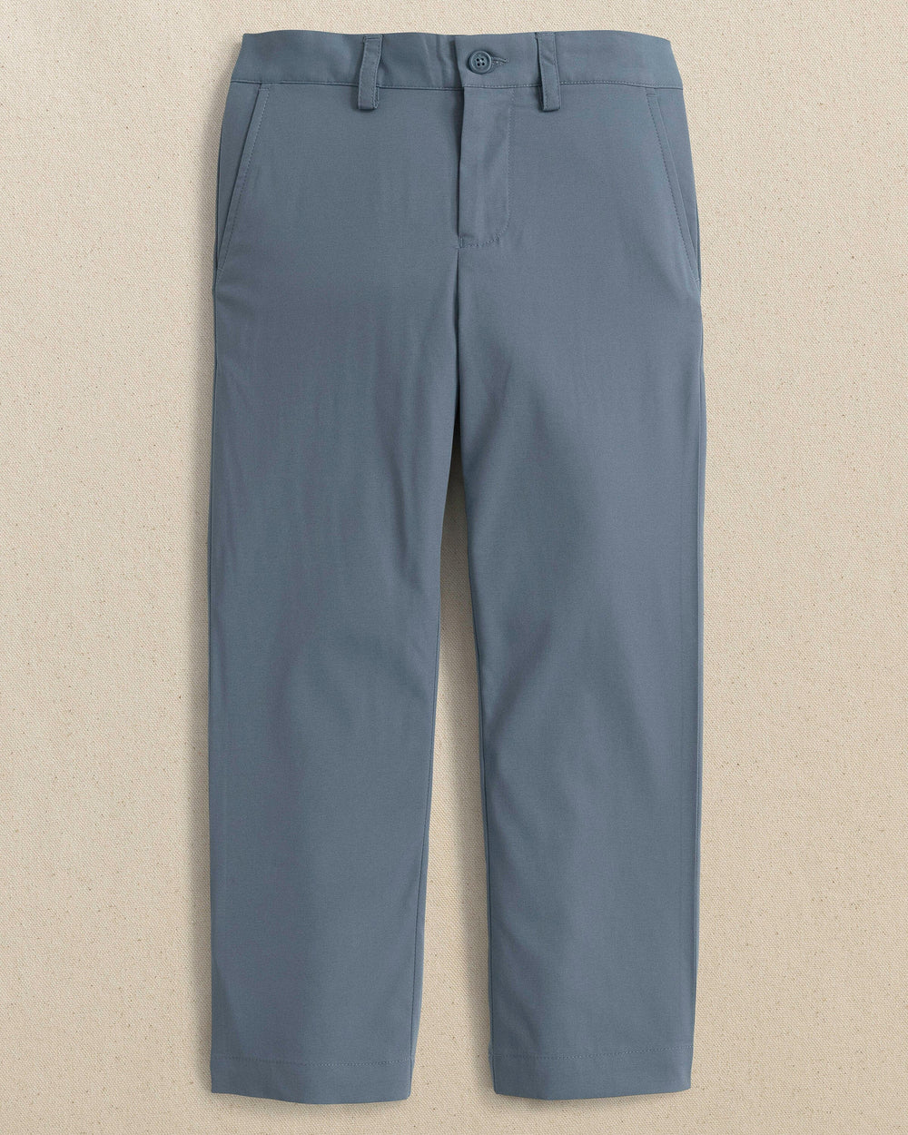 The front view of the Youth Leadhead Performance Pant by Southern Tide - Blue Haze