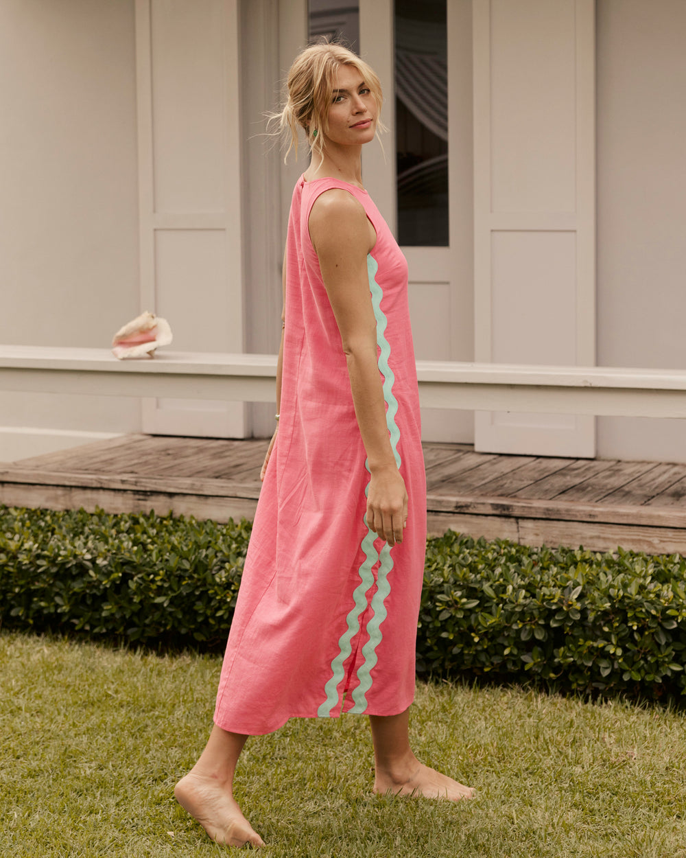 The lifestyle view of the Southern Tide Zalia Side Stripe Maxi Dress by Southern Tide - Island Pink