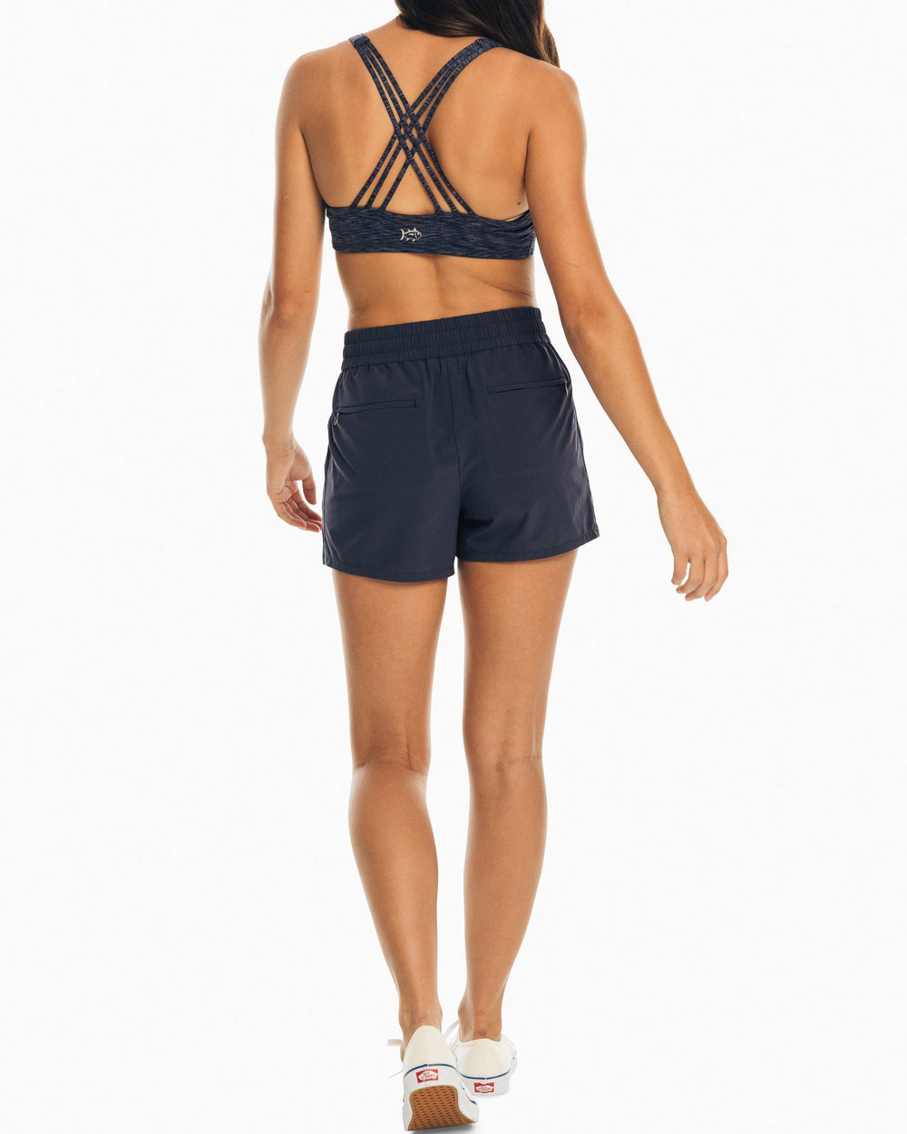 The back view of the Women's Navy Coastal Performance Solid Short by Southern Tide - Nautical Navy