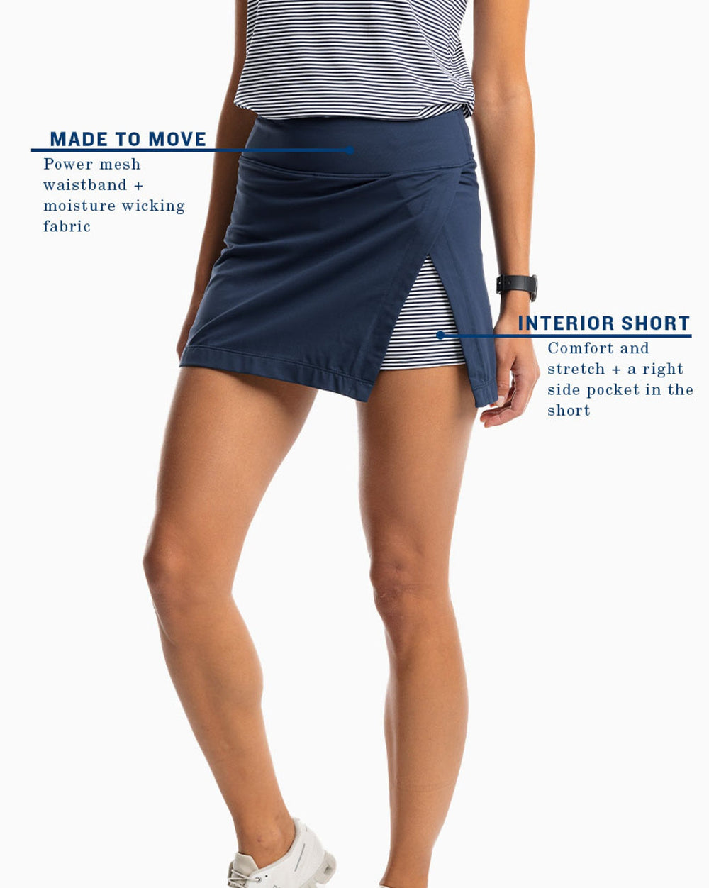 The model highlights view of the Women's Aveiro Performance Skort by Southern Tide - True Navy