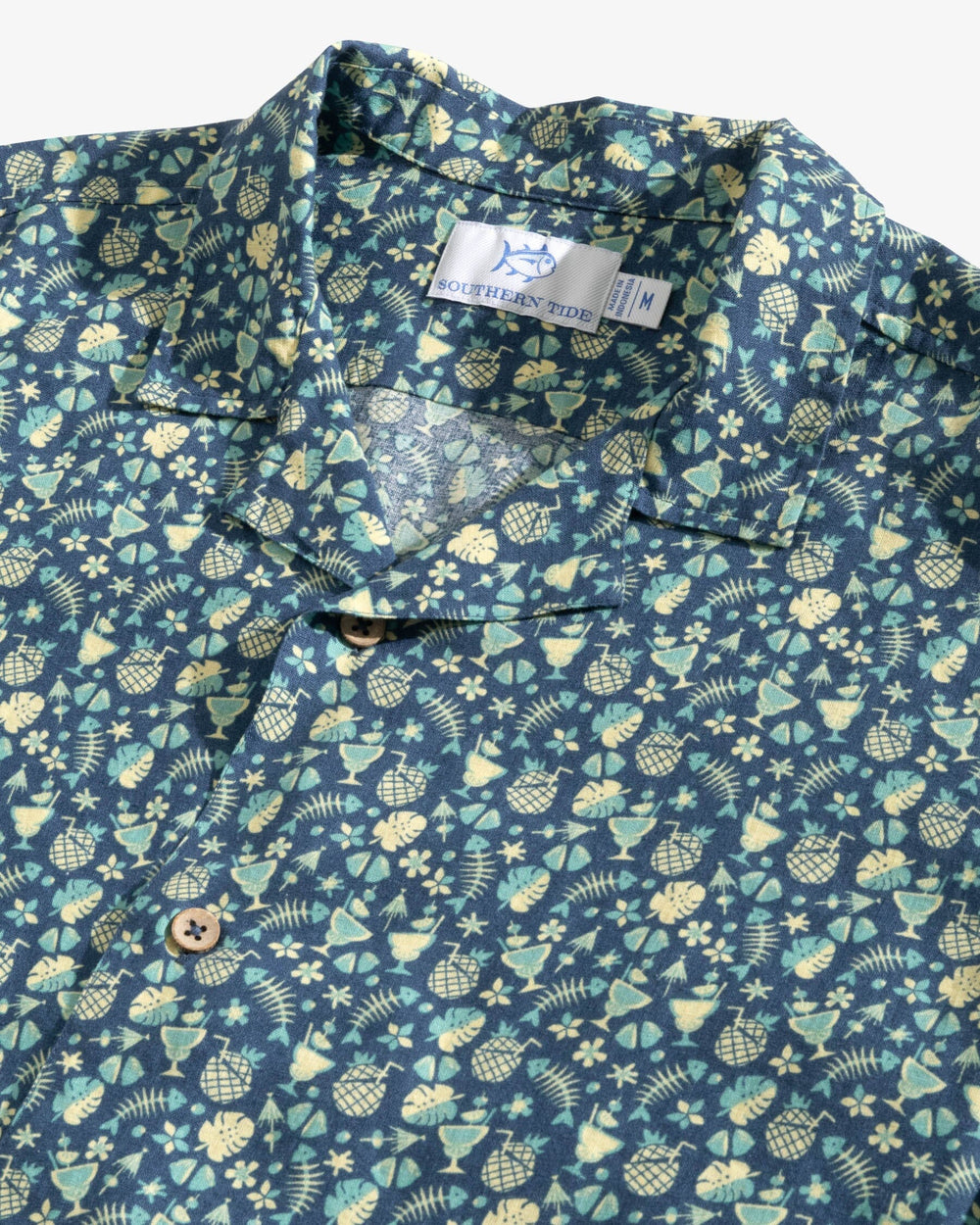 The detail view of the Southern Tide Bad and Boozy Camp Short Sleeve Button Down Sport Shirt by Southern Tide - Aged Denim