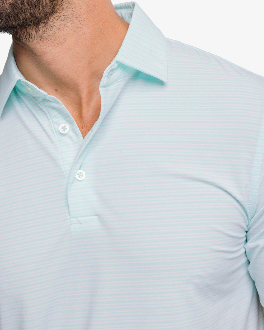 The detail view of the Southern Tide brrr-eeze Millwood Stripe Performance Polo Shirt by Southern Tide - Baltic Teal