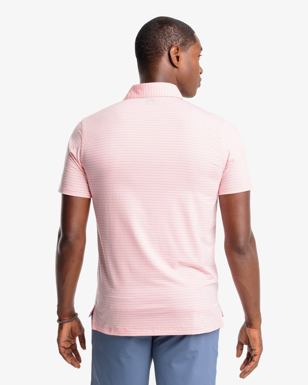 The back view of the Southern Tide brrr-eeze Millwood Stripe Performance Polo Shirt by Southern Tide - Flamingo Pink