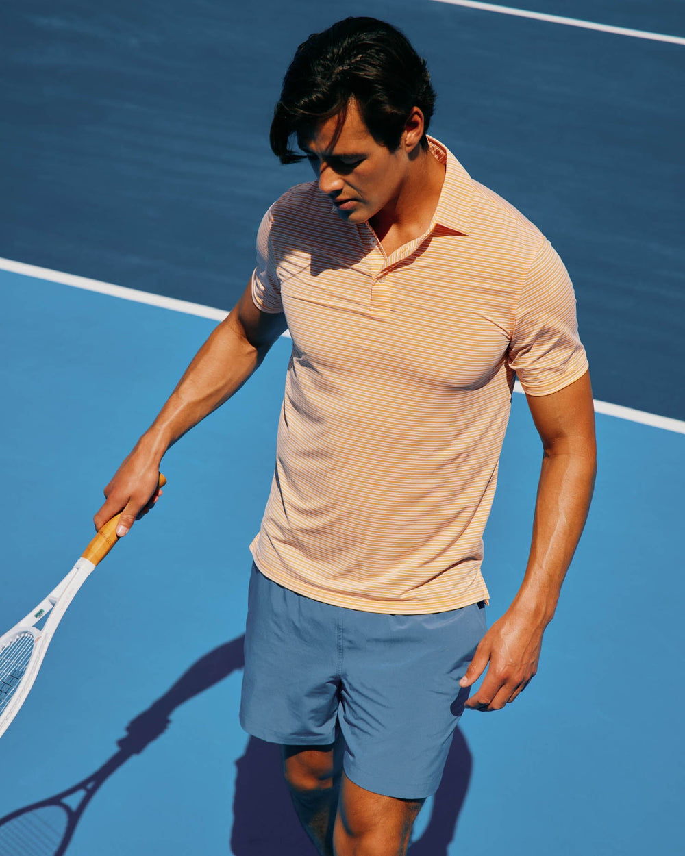 The lifestyle view of the Southern Tide brrr-eeze Millwood Stripe Performance Polo Shirt by Southern Tide - Horizon