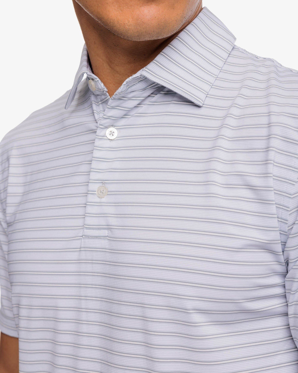 The detail view of the Southern Tide Brrreeze Crawford Stripe Performance Polo Shirt by Southern Tide - Slate Grey