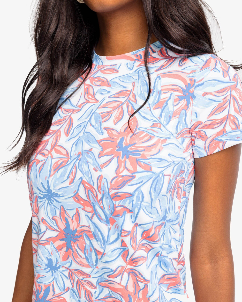 The detail view of the Southern Tide Chanelle TGIFloral Performance Dress by Southern Tide - Sunkist Coral
