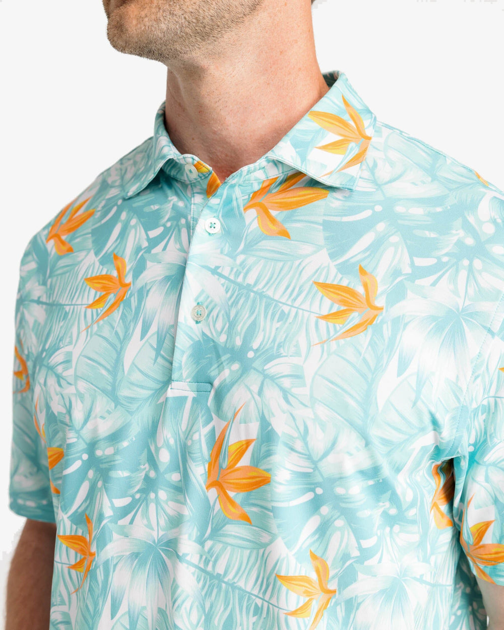 The detail view of the Southern Tide Driver Monstera Palm Pring Performance Polo Shirt by Southern Tide - Cloud White