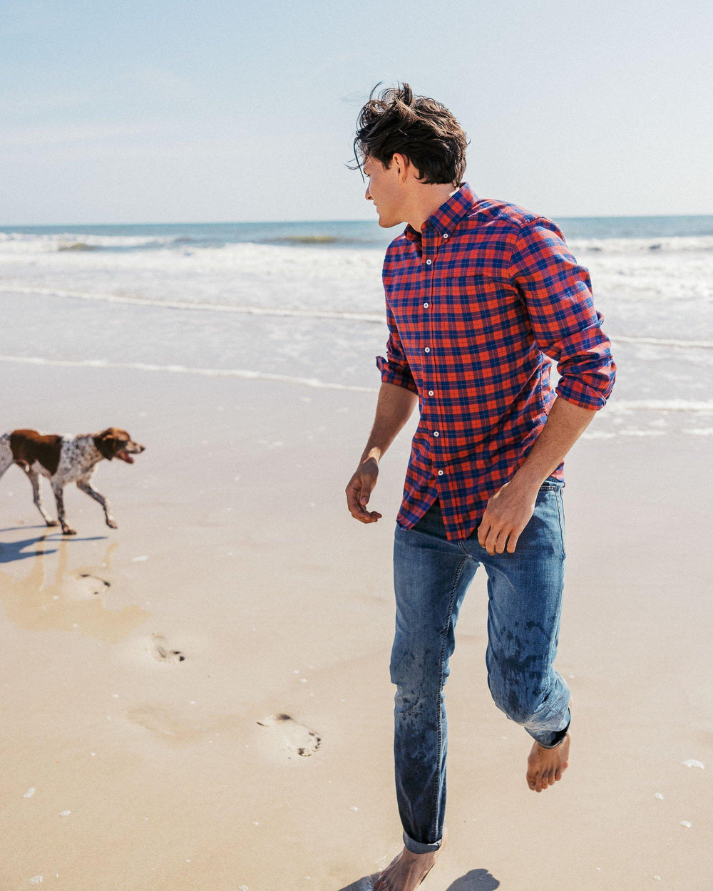 The lifestyle view of the Men's Navy Charleston Denim Jeans by Southern Tide - Medium Wash