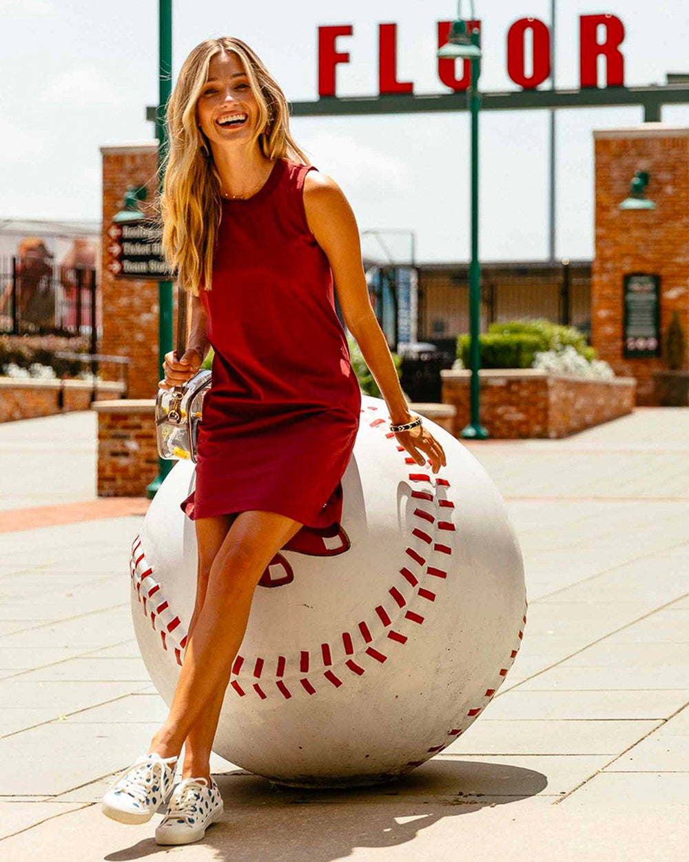 The lifestyle view of the Women's Red Gameday Dress by Southern Tide - Chianti