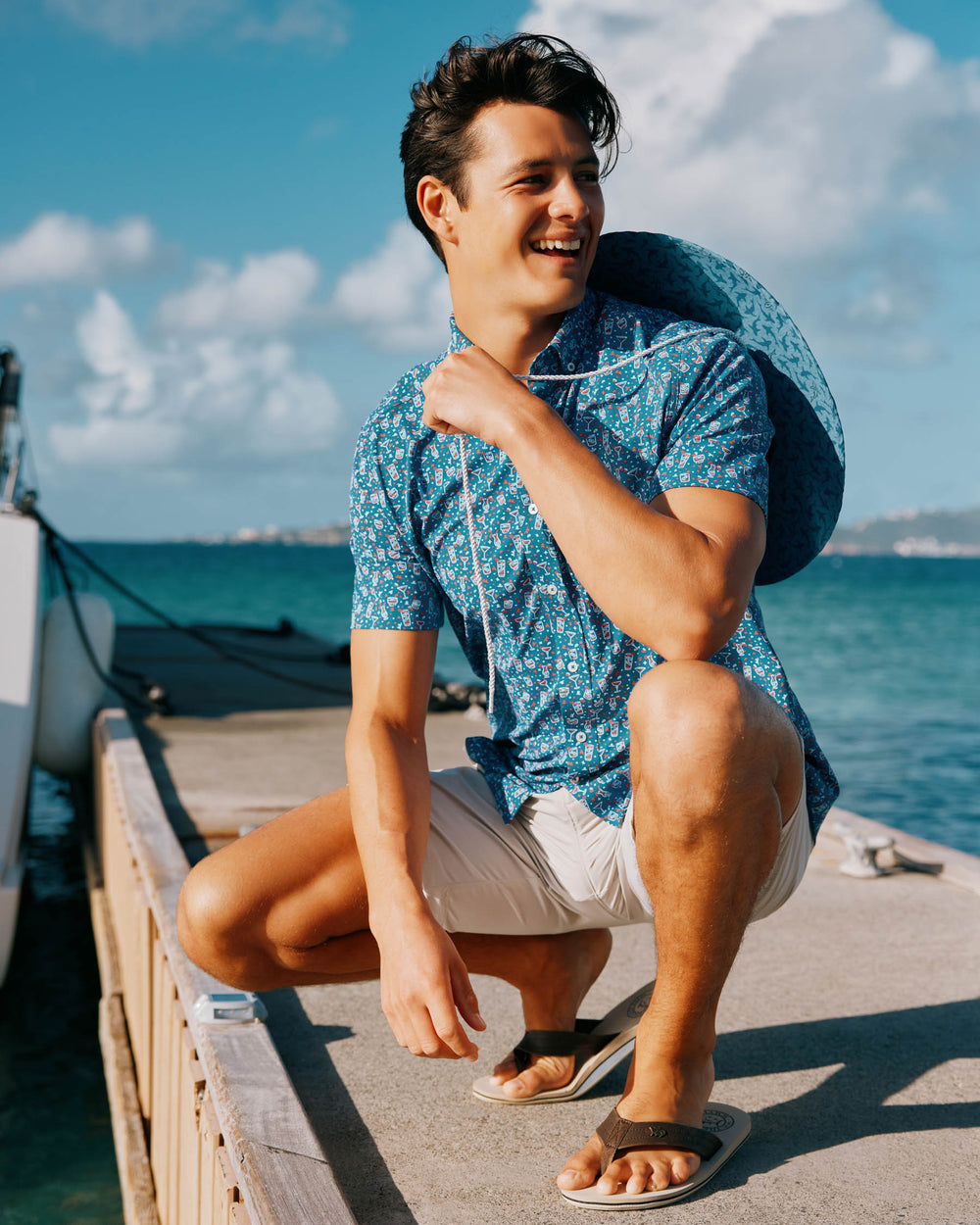 The lifestyle view of the Men's Let the Party Be-Gin Short Sleeve Button Down Shirt by Southern Tide - Deep Water