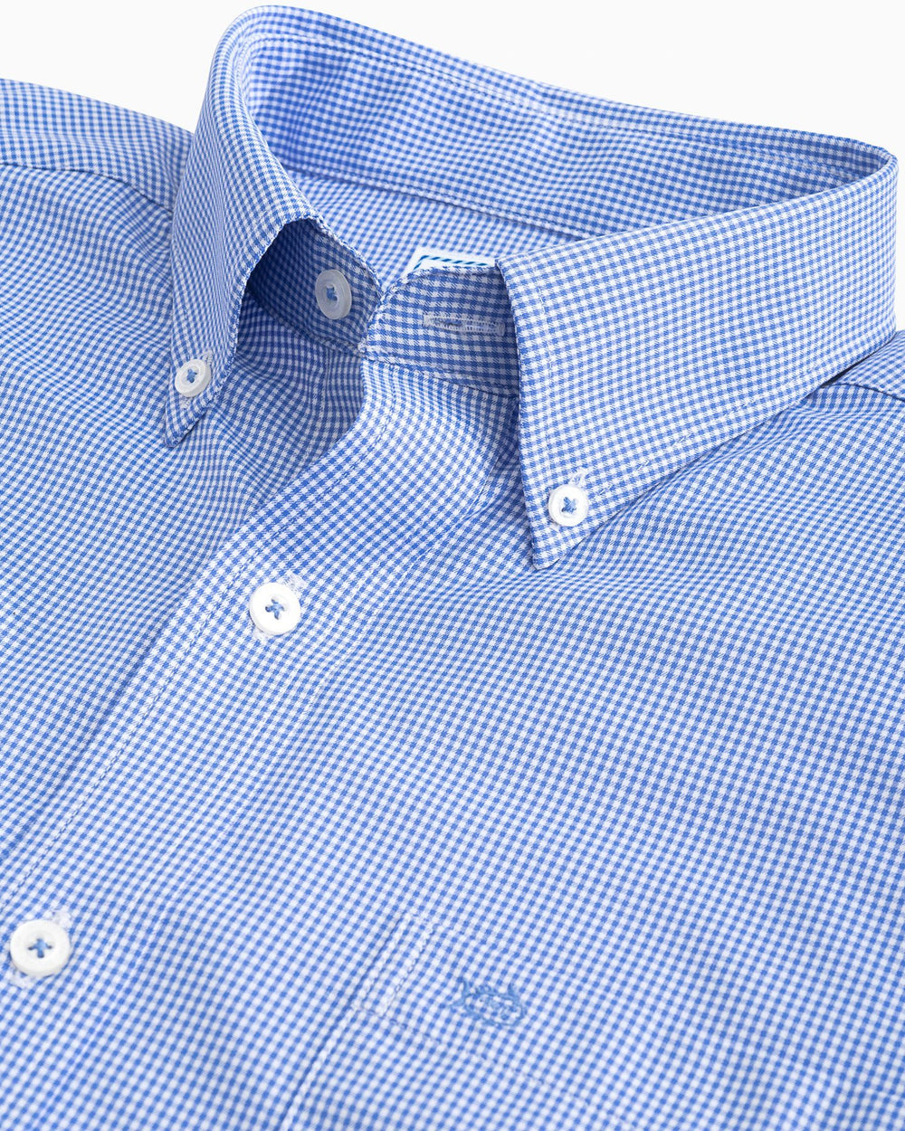The collar of the Men's Navy Micro Gingham Intercoastal Performance Sport Shirt by Southern Tide - blue cove