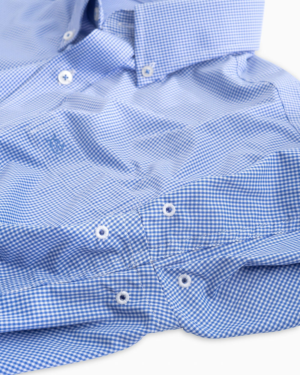 Arm vents of the Men's Navy Micro Gingham Intercoastal Performance Sport Shirt by Southern Tide - blue cove