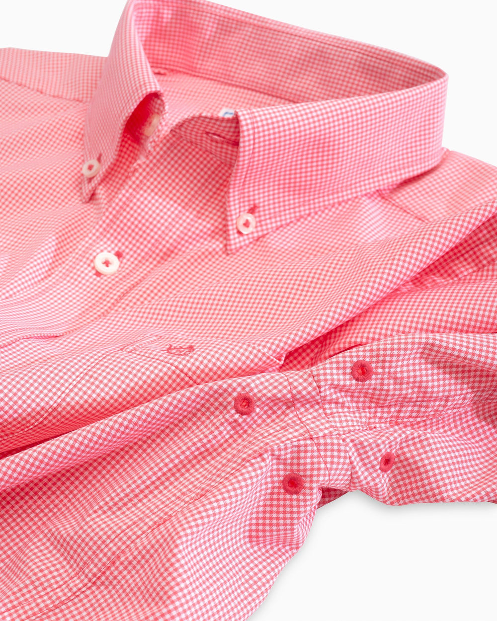 Arm vents of the Men's Pink Micro Gingham Intercoastal Performance Sport Shirt by Southern Tide - Sunkist Coral