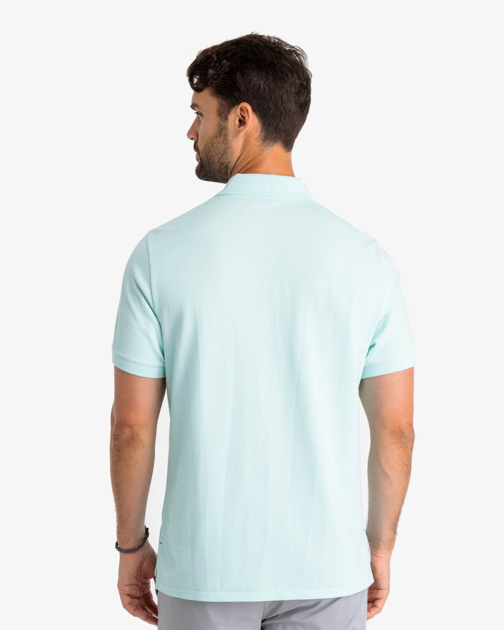 The model back view of the Men's New Skipjack Polo Shirt by Southern Tide - Baltic Teal