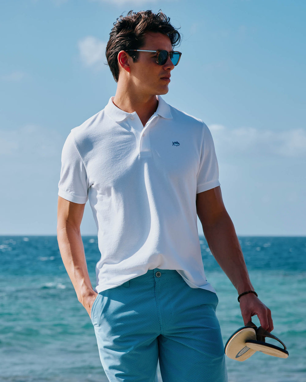 The model lifestyle front view of the Men's New Skipjack Polo Shirt by Southern Tide - Classic White