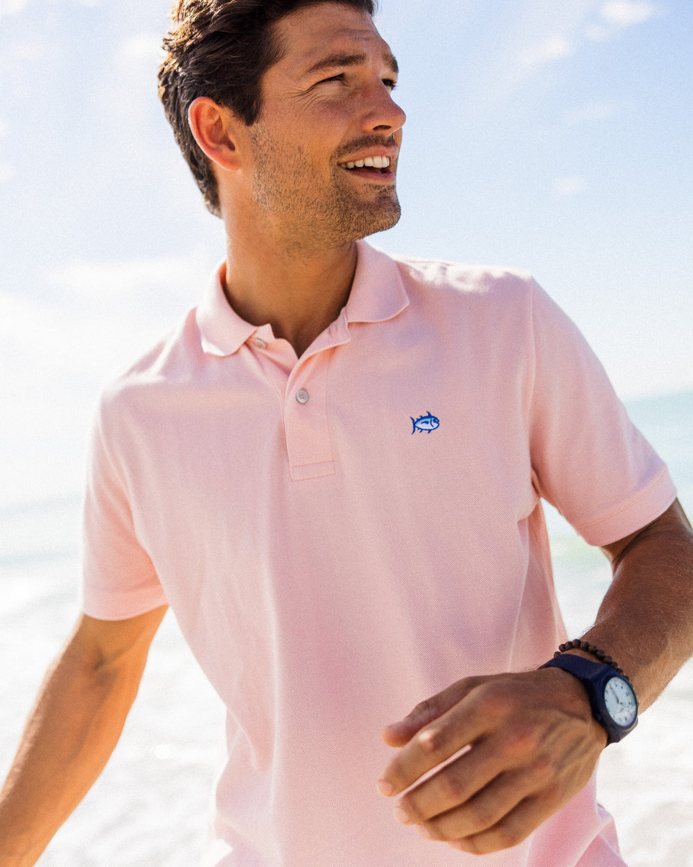 The model lifestyle view of the Men's New Skipjack Polo Shirt by Southern Tide - Light Pink