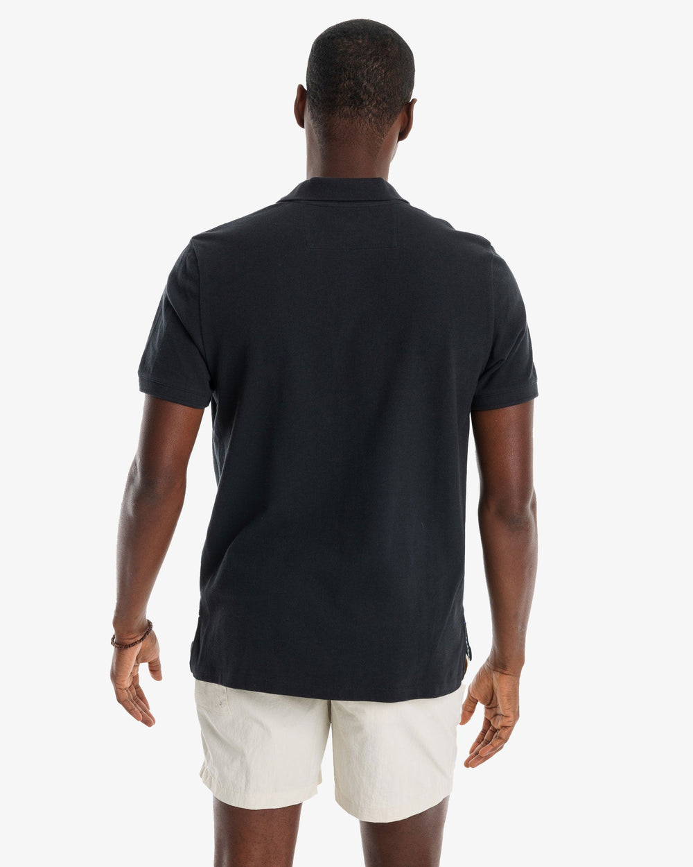 The model back view of the Men's New Skipjack Polo Shirt by Southern Tide - Midnight Black