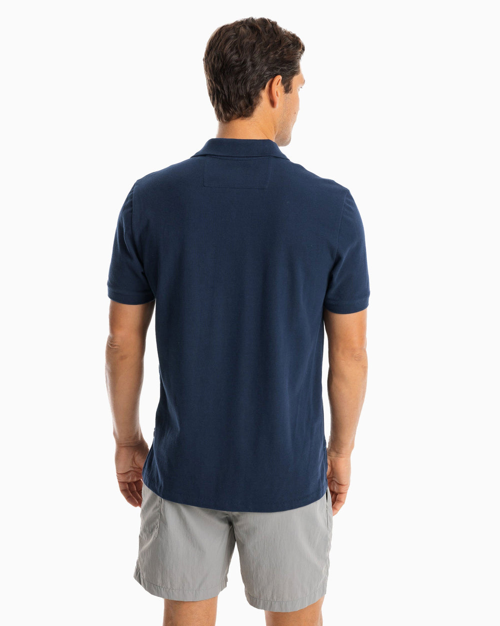 The model back view of the Men's New Skipjack Polo Shirt by Southern Tide - True Navy