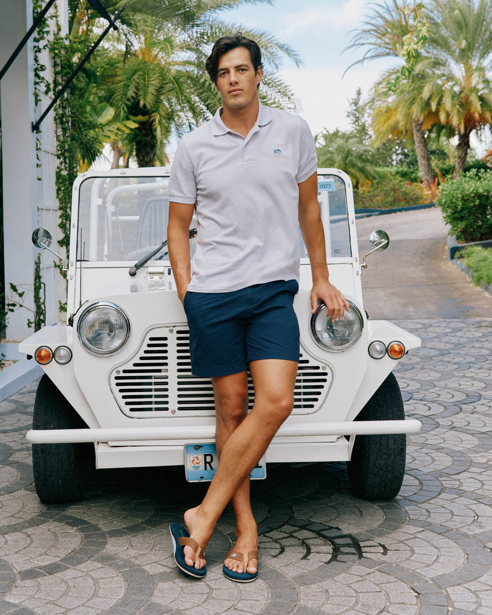The lifestyle back view of the Men's New Skipjack Polo Shirt by Southern Tide - Slate Grey
