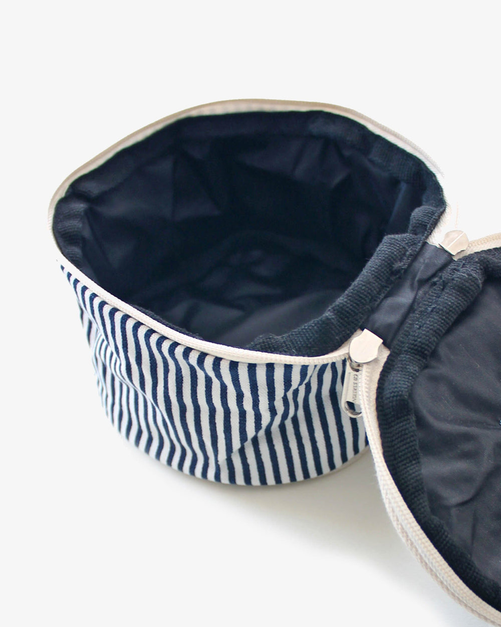 The interior view of the Southern Tide Palm Striped Circle Case by Southern Tide - Navy