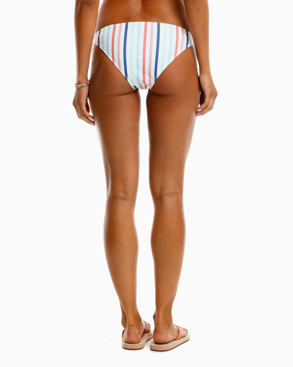 The model back view of the Women's Patio Party Stripe Bikini Bottom by Southern Tide - Rouge Red