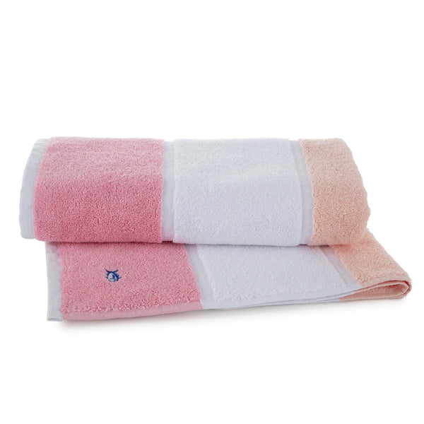 the rolled view of the Performance Striped Bath Towel in Coral by Southern Tide - Coral