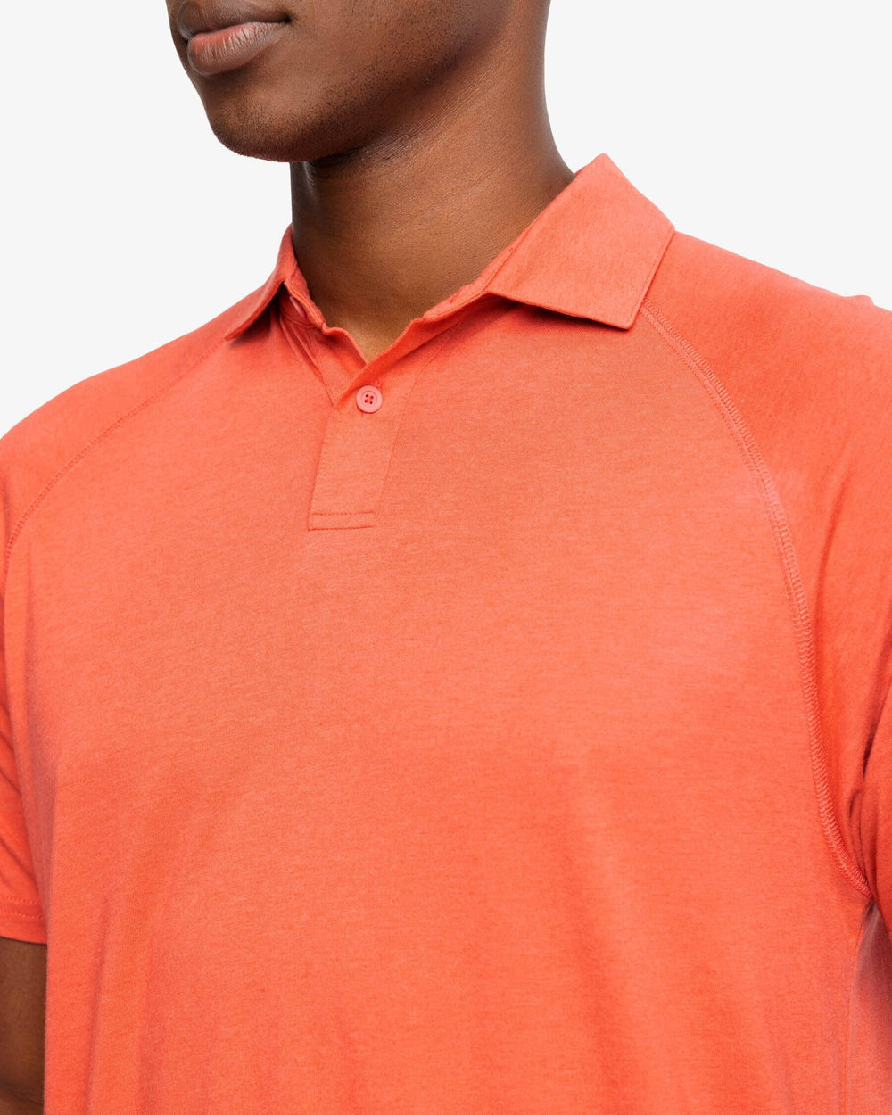 The detail view of the Racquet Performance Polo Shirt by Southern Tide - Mineral Red