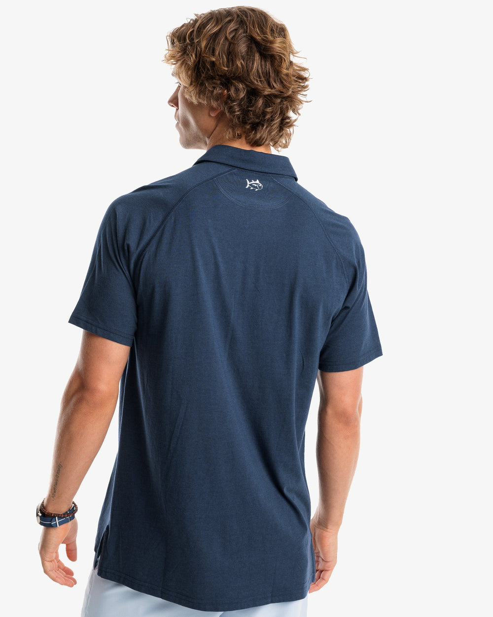 The model back view of the Men's Racquet Performance Polo Shirt by Southern Tide - True Navy
