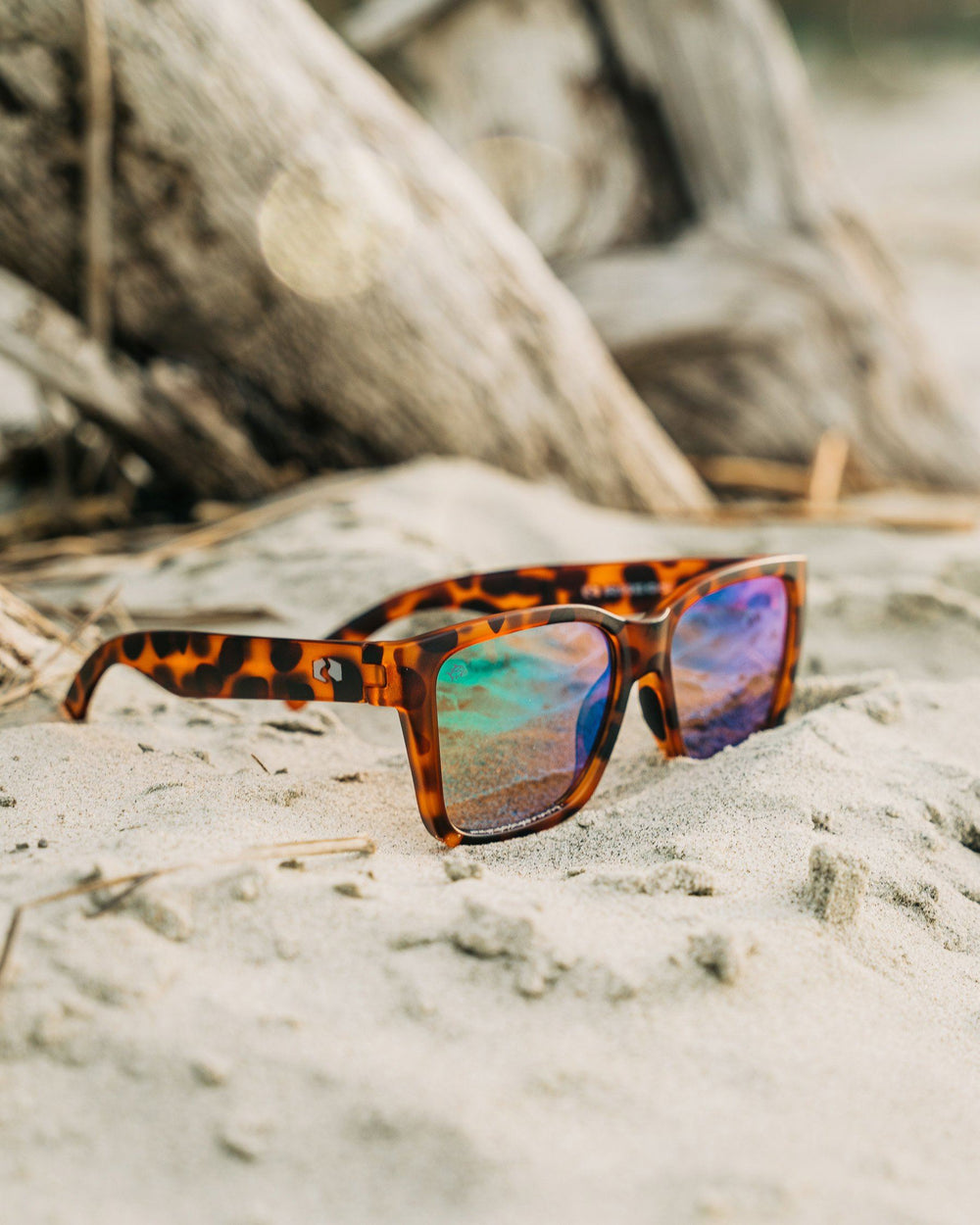 The lifestyle view of the Rheos Edistos Sunglasses by Southern Tide - Tortoise Marine